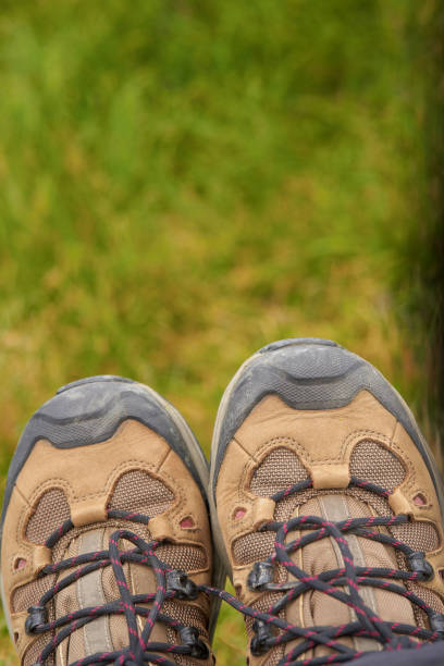 Close-up of hiking boots on grass